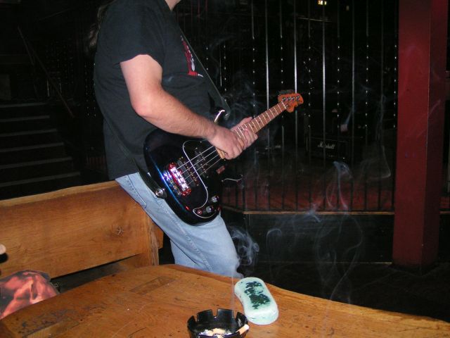 Guy having a pre gig ciggie - wow look at that bass - awesome or what.